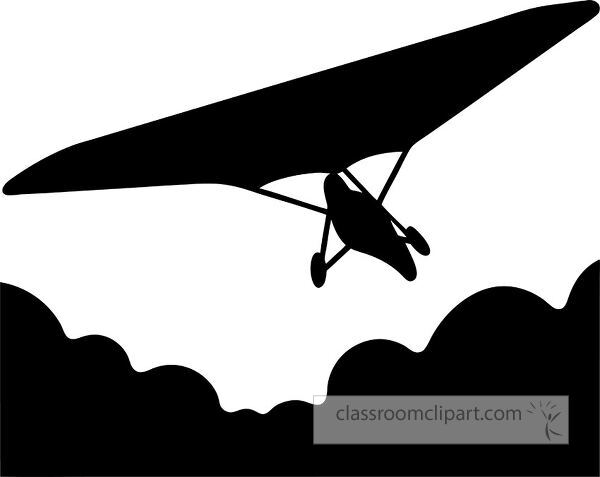 A silhouette of a hang glider soaring above clouds