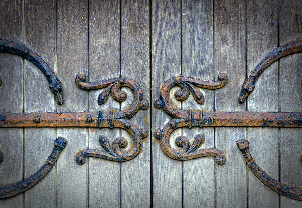 old-wooden-door-with-ornamental-metal-photo.jpg