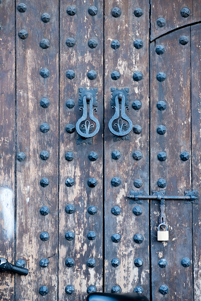 ornate-wooden-door-with-metal-divets.jpg
