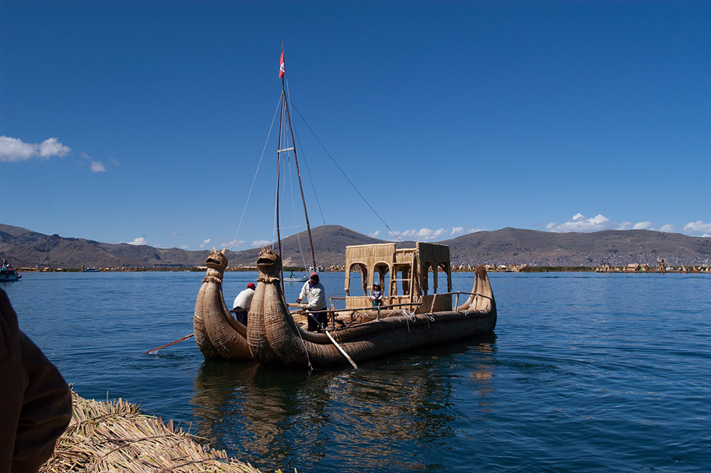 man-manuevering-reed-boat-on-lake-titicaca.jpg