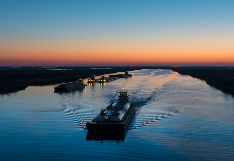photo-of-barges-traversing-a-short-canal.jpg