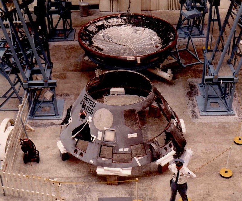 an-officer-stands-guard-in-front-of-the-disassembled-apollo-204.jpg