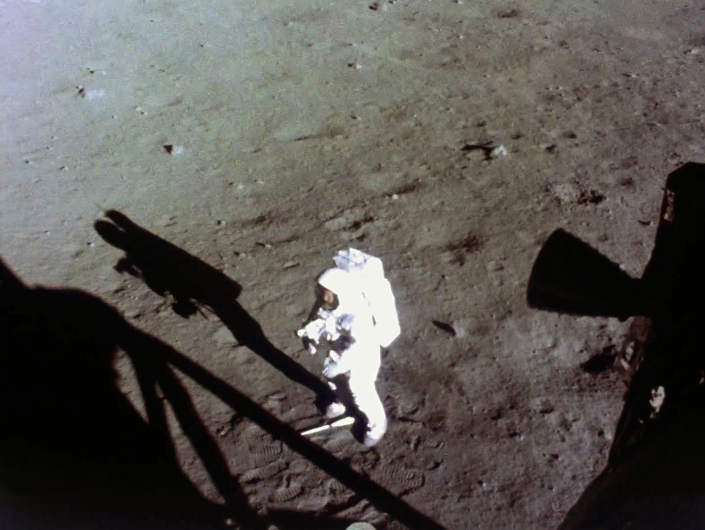neil-armstrong-with-his-gold-visor-raised-and-face-visible-works-near-the-lm-early-in-the-apollo-11-eva.jpg
