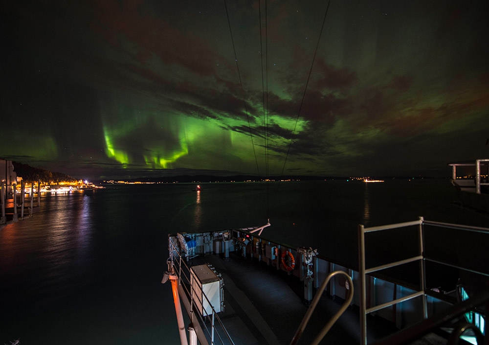 ship moored under northern lights in norway.jpg