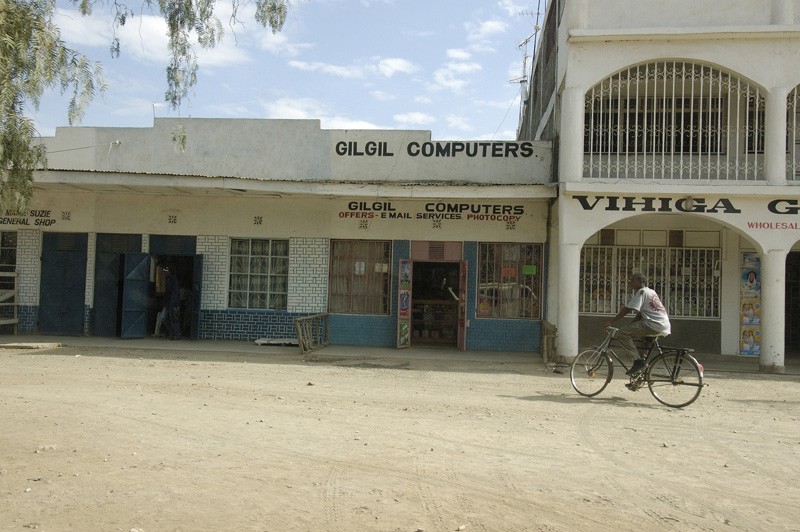 man-riding-bike-near-small-businesses-in-kenya-africa.jpg